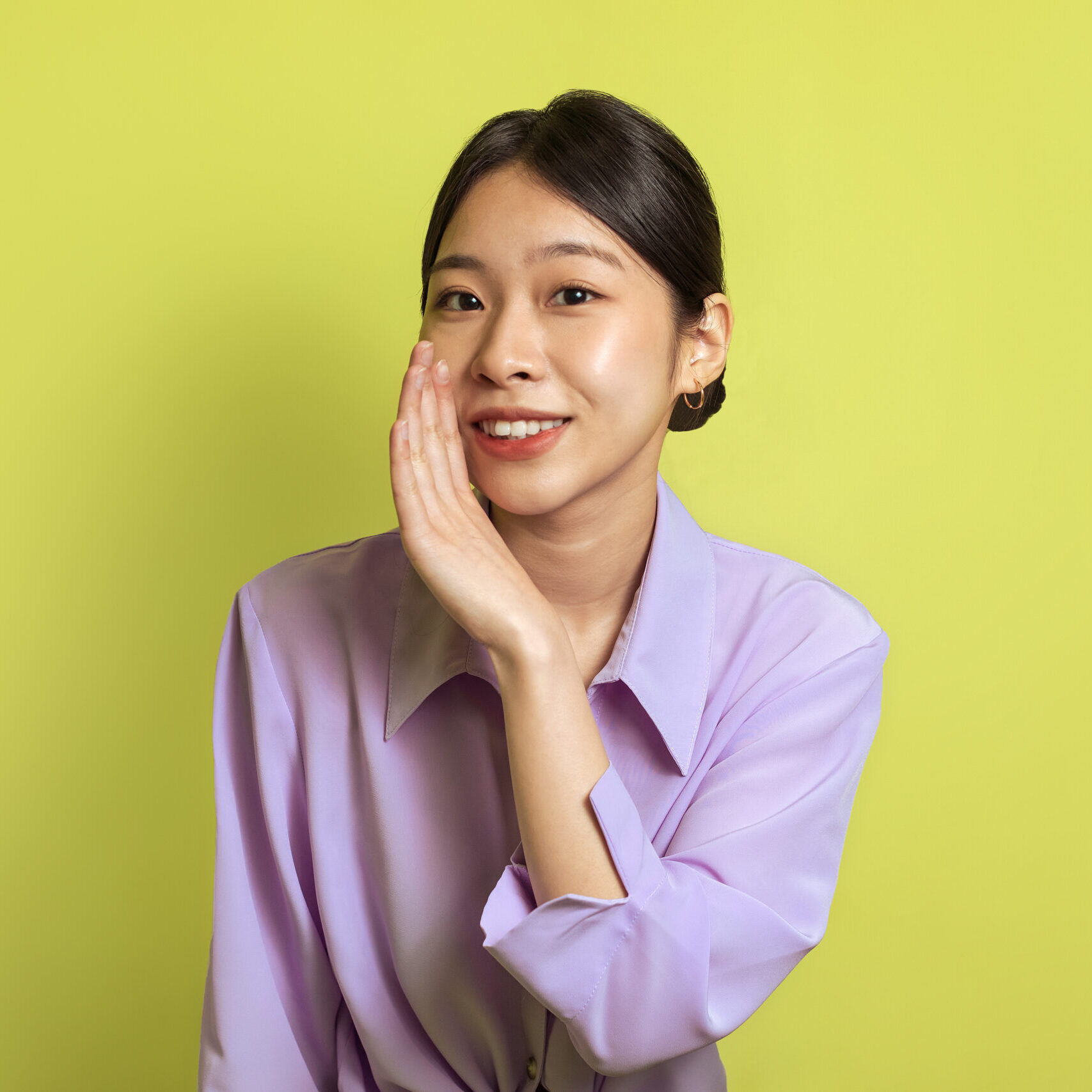 Secret Offer. Smiling Japanese Woman Whispering Holding Hand Near Mouth Looking At Camera, Spreading Gossips And Sharing Information Posing Over Yellow Background. Studio Shot