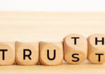 Truth or trust concept. Text on wooden blocks. White background. Copy space